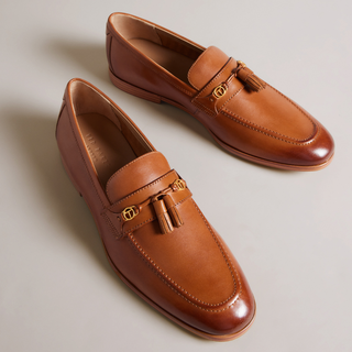 Ainsly by Ted Baker is a classic tan gentlemans loafer with gold buckle and tassle details
