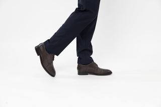Ted Baker, Kampten, Brown leather dinner shoes with pointed toes and brown laces styled with dress pants and modelled with feet and legs, The Shoe Curator