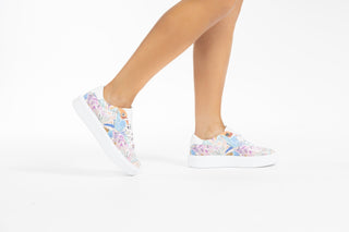 Ted Baker, Lorma, White sneakers with light floral designs with white laces modelled with feet and legs, The Shoe Curator
