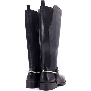 Knee-high leather boots, with ankle strap and metal hardware