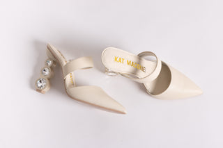 Cream leather, pointed closed toe Kat Maconie mule with a symmetrical strap over arch of foot stack on 3 crystal heel