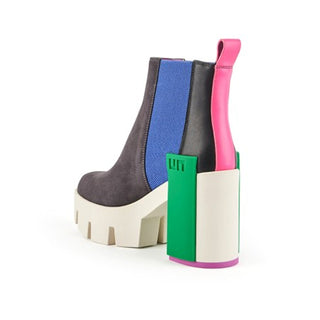 Suede gray boot with white lug sole, green statement block, electric blue elastic pull and pink and black features