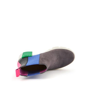 Suede gray boot with white lug sole, green statement block, electric blue elastic pull and pink and black features