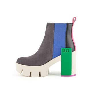 Suede gray boot with white lug sole, green statement block, electric blue elastic pull and pink and black features