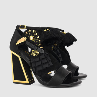 Kat Maconie, Aya, Black suede and patent shoe with open toes and bird detailing with gold and pom pom extras, block heel with gold edging, The Shoe Curator