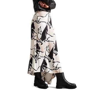 Women styled in a Ted Baker leather black jacker, black and white floaty skirt styled with Black leather ankle chelsea boots with whipstitch detail, pull tap at the heel, elasticated panels, round toe