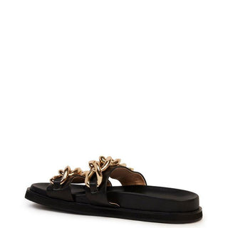 Verona slide in black by Kathryn Wilson is the go-to sandal of the season. Made with calf leather, this slide features two chunky, gold chains over the toe straps.