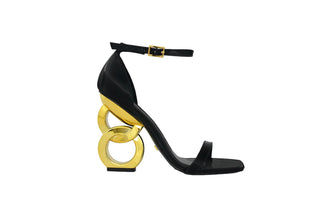 Kat Maconie, Suzu, Black leather stiletto with thin straps and gold buckle strap and a gold patent chain heel, The Shoe Curator