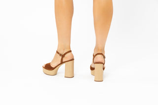 Unisa, Rafia, Brown suede with peeped toe and adjustable ankle strap with textures light brown block heel and sole modelled with feet and legs, The Shoe Curator
