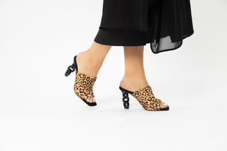 Kat Maconie, Kylie, Leopard print suede peeped toe high heel with a black link chain heel styled with long black dress and modelled with legs and feet, The Shoe Curator