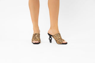 Kat Maconie, Kylie, Leopard print suede peeped toe high heel with a black link chain heel modelled with feet and legs, The Shoe Curator