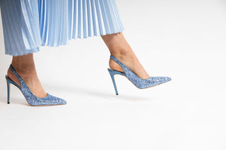 Gianna Meliani, Andy, Light blue sparkly slingback pump with pointed toes and a blue leather stiletto heel styled with long blue dress and modelled with legs and feet, The Shoe Curator