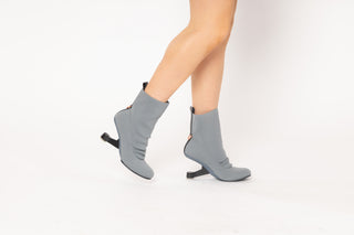 United Nude, Eamz Fab Bootie, Copenhagen stretchy fabric with a floating heel, round toes and hook on the back modelled with feet and legs, The Shoe Curator