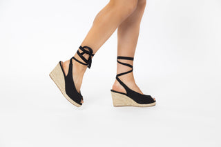 Cafe Noir, Cali, Black wedge with peeped toe and wrap around tie and natural coloured heel with woven texture modelled with feet and legs, The Shoe Curator