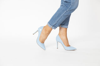 Capelli Rossi pastel blue patent pumps with pointed heels and stiletto heel styled with jeans and modelled with legs and feet, Tess, The Shoe Curator