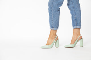 Capelli Rossi pastel green shoe with a slingback strap and pointed toes with a croc patterned block heel styled with jeans on legs and feet, Annie, The Shoe Curator