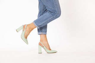Capelli Rossi pastel green shoe with a slingback strap and pointed toes with a croc patterned block heel styled with jeans on legs and feet, Annie, The Shoe Curator