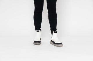 Lemon Jelly, Laney, White patent ankle boot with Black elastic sides and big thick clear tread styled with black jeans modelled with legs and feet, The Shoe Curator
