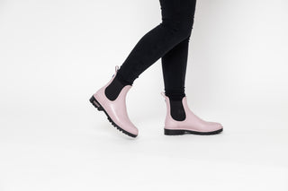 Verbenas, Gaudi, Pastel Pink ankle boot with black elastic sides and big thick black tread styled with black jeans modelled with feet and leg, The Shoe Curator