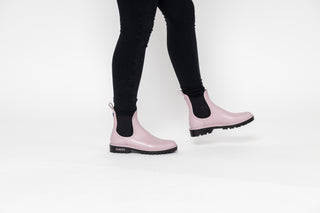 Verbenas, Gaudi, Pastel Pink ankle boot with black elastic sides and big thick black tread styled with black jeans modelled with feet and legs, The Shoe Curator