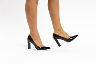 Capelli Rossi Black patent stiletto with pointed toes and white rubber tread, patent black block heel modelled with feet and legs, Caroline, The Shoe Curator
