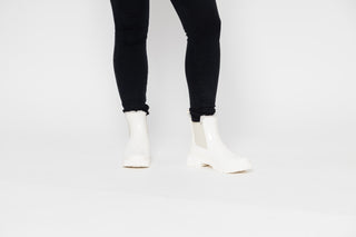 Lemon Jelly, Colden, White patent ankle boot with fluffy insides and cream elastic sides and big thick tread styled with black jeans modelled with feet and legs, The Shoe Curator