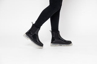 Lemon Jelly, Laney, Black patent ankle boot with black elastic sides and big thick clear tread styled with black jeans modelled with feet and legs, The Shoe Curator