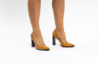 Capelli Rossi caramel orange leather pump with pointed toes and black patent block heel modelled with feet and legs, Victoria, The Shoe Curator