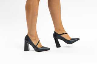 Capelli Rossi black leather mary-jane pump with pointed toes and a patent black block heel and patent black thin strap modelled with feet and legs, Duffy, The Shoe Curator.