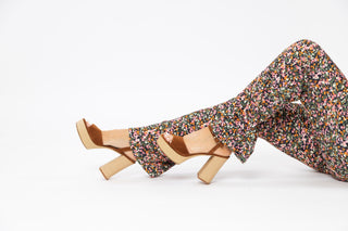 Unisa, Rafia, Brown suede with peeped toe and adjustable ankle strap with textures light brown block heel and sole styled with multi coloured pants and modelled with feet and legs, The Shoe Curator