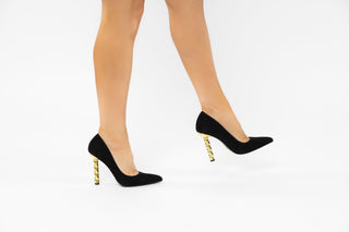 Kat Maconie, Lydia, Black suede stiletto with pointed toes and a twisted gold chain heel modelled with legs and feet, The Shoe Curator