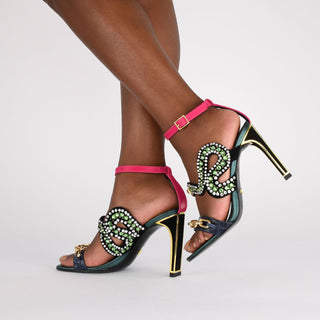 Kat Maconie, Yazz, Black suede with multi coloured crystals in the shape of a serpent and blue metallic croc leather with gold chain across toes, included a slim-wide heel with gold edging and a hot pink buckle strap modelled with feet and legs, The Shoe Curator