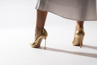 Casadei, Scarpa Mermaid, Gold sequenced stiletto with pointed toes and a thin gold heel, shimmery gold modelled with feet and legs styled with long white flowy dress, The Shoe Curator