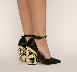 Kat Maconie, Emmi, Black leather heel with pointed toes and thin strap, gold patent chain heel modelled with feet and legs, The Shoe Curator