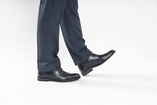 Fluchos, Adrian, Dark blue leather shoe with textured sides and 4 lace holes styled with dress pants and modelled with feet and legs, The Shoe Curator