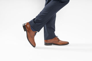 Fluchos, Dan, Light brown leather mens shoe with pointed toes and small stich detailing with blue laces modelled with feet and legs, The Shoe Curator