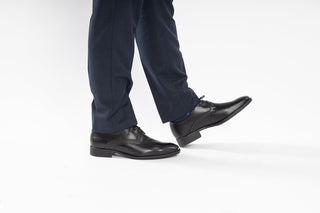 Fluchos, Wright, Black leather slim squared shoe with stiching side and back detailed and dark laces modelled with feet and legs, The Shoe Curator
