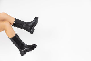 Gioseppo, Limuru, Black leather mid-calf boot with zip and elastic chunk and black rubber sole modelled with feet and legs, The Shoe Curator