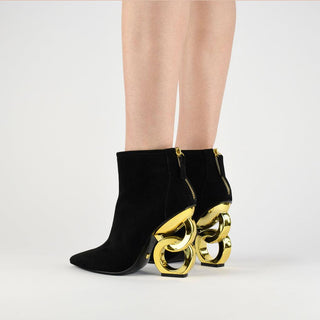 Kat Maconie, Dara, black low cut suede leather boot with pointed toe with zip and gold patent chain heel modelled with legs and feet, The Shoe Curator