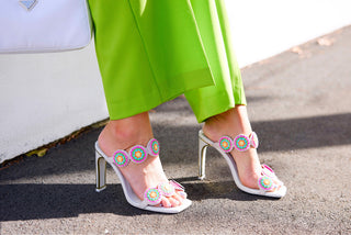 Kat Maconie, Iza, white leather high heels with light shades of multi colours in flower designs, slim-wide block heel with gold edging styled with lime green pants and modelled with feet and legs, The Shoe Curator