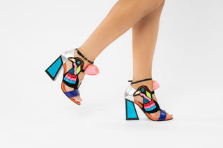 Kat Maconie, Aya, Blues and pinks leather pump with block heel and pop pom detailing and peeped toe and bird design out of tassels and sequences with adjustable ankle strap modelled with feet and legs, The Shoe Curator
