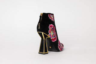 Kat Maconie, Lucie, Ankle boot with suede black and colourful flower designs with pointed toes and a zip on the back, hourglass black heel with gold edging, The Shoe Curator