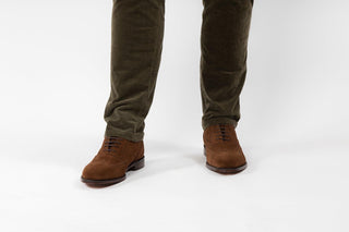 Loake, Brown Suede slim squared shoe with dot detailing through the stitching modelled with feet and legs, The Shoe Curator