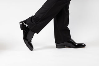 Loake, Patent Black, Black Patent males shoe with slim squared toes and one stitch through the shoe modelled with feet and legs, The Shoe Curator
