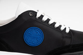 Ted Bake, Areli, Black and white sneaker with white laced and white sole with blue detailing at the front and back, The Shoe Curator