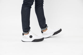 Ted Baker, Areli, White sneakers with black detailing on the front and side modelled with feet and legs, The Shoe Curator
