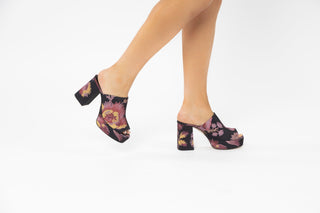 Ted Baker, Delmia, Black and sunset coloured flowered mules with peeped toes and block heel modelled with feet and legs, The Shoe Curator