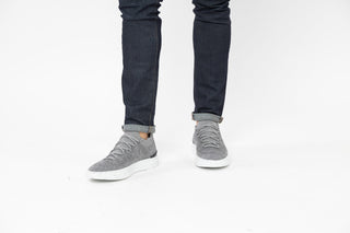Ted Baker, Edmond, Grey marble sneakers with white soles and grey laces styled with jeans and modelled with feet and legs, The Shoe Curator