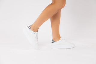 Ted Baker, Filona, White sneakers with blue checker pattern on the heel modelled with feet and legs, The Shoe Curator