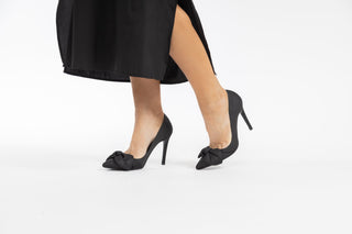 Ted Baker, Hyana,Black striped leather stiletto with pointed toes and bow on the front styled with dress and modelled with feet and legs, The Shoe Curator